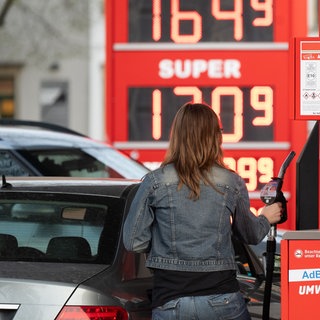 Eine Frau tankt ihre Auto an einer Tankstelle. | Schwankende Benzinpreise: Tankstellenpächter kritisieren die Mineralölkonzerne